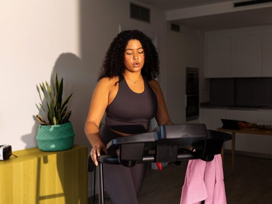 Woman walking on a walking treadmill to make herself feel better.